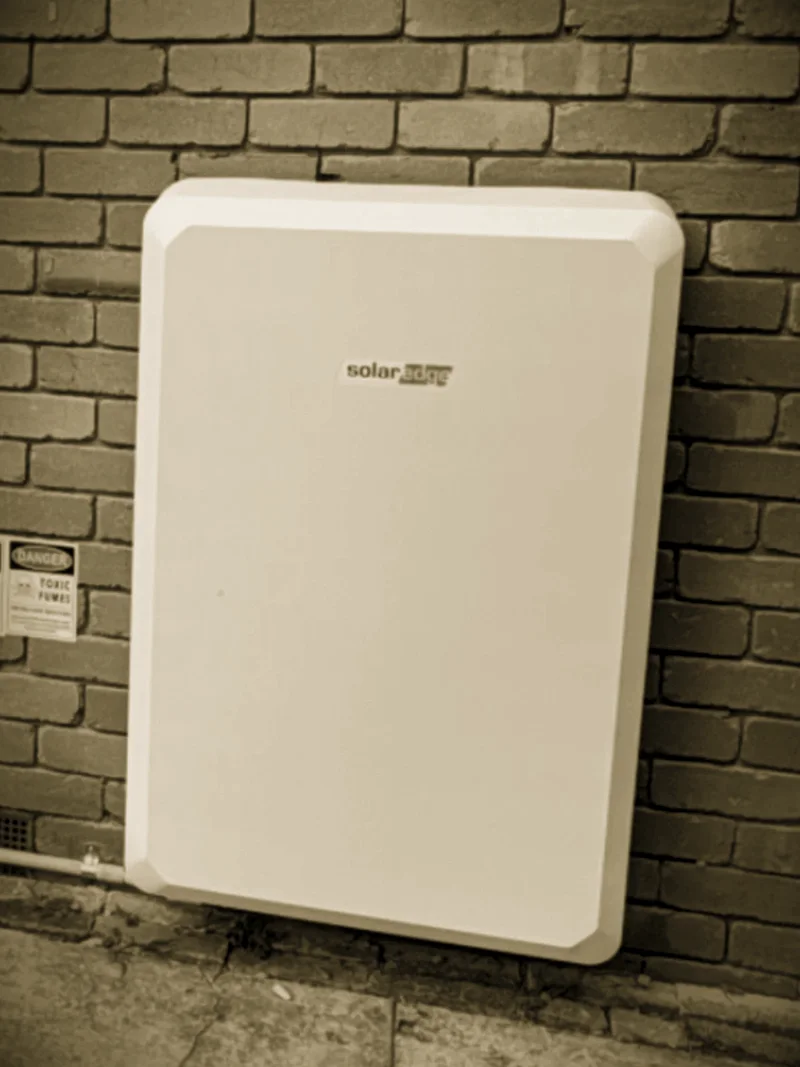 A SolarEdge battery installed by Primero on a brick wall