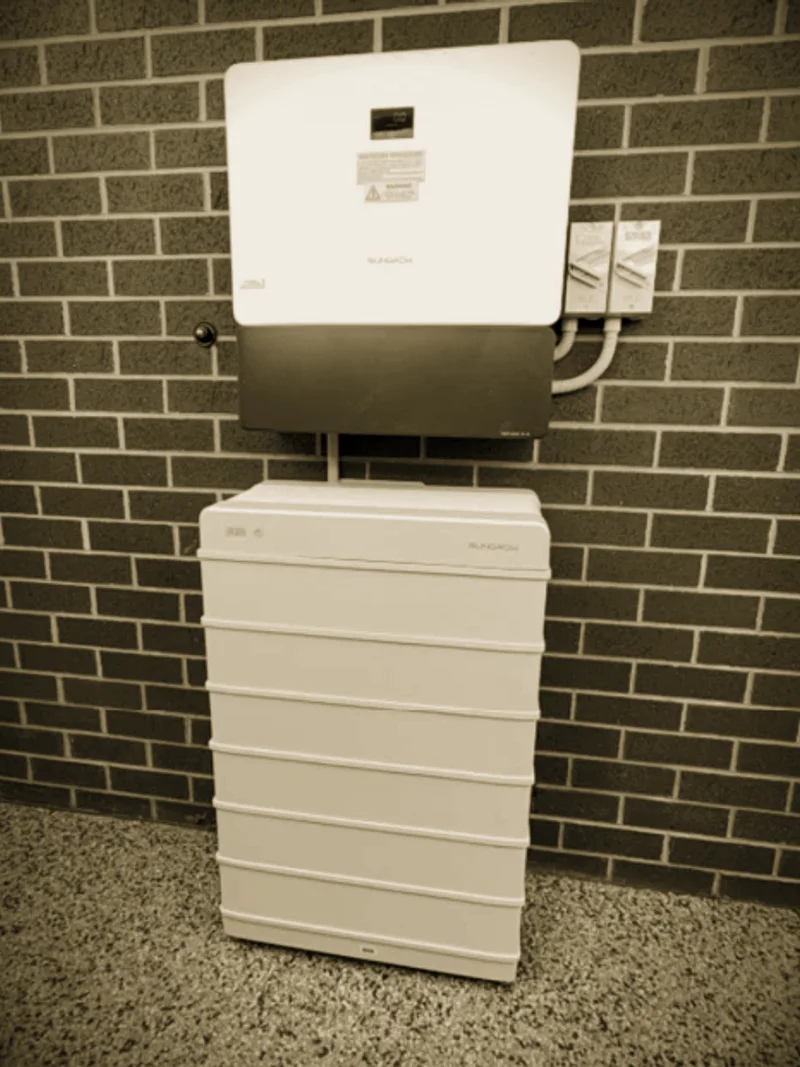 A Sungrow inverter and battery stack installed by Primero on a brick wall